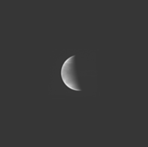 This image shows a crescent Venus. It shows some faint detail in the planet's cloud tops.