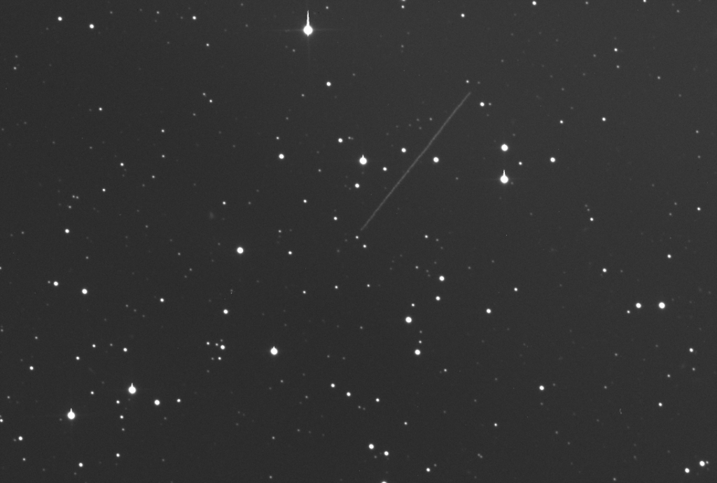 The image shows a star field with a long streak as asteroid 2015 RN35 passes from middle center to upper right.